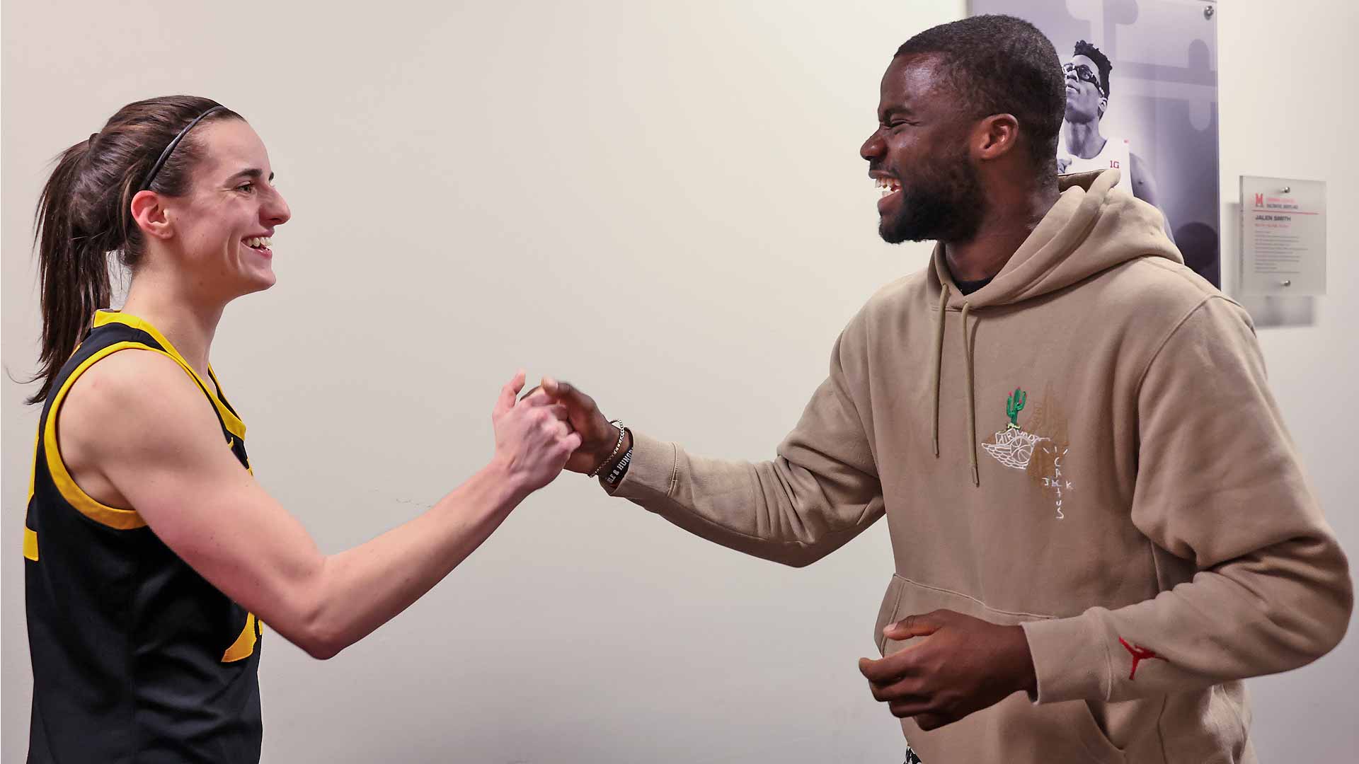 Caitlin Clark and Frances Tiafoe meet after the University of Iowa's game on Saturday.